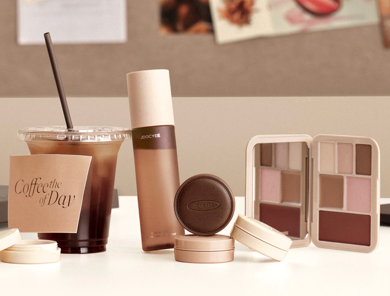 JOOCYEE products arranged with an iced coffee in a warm neutral editorial still life